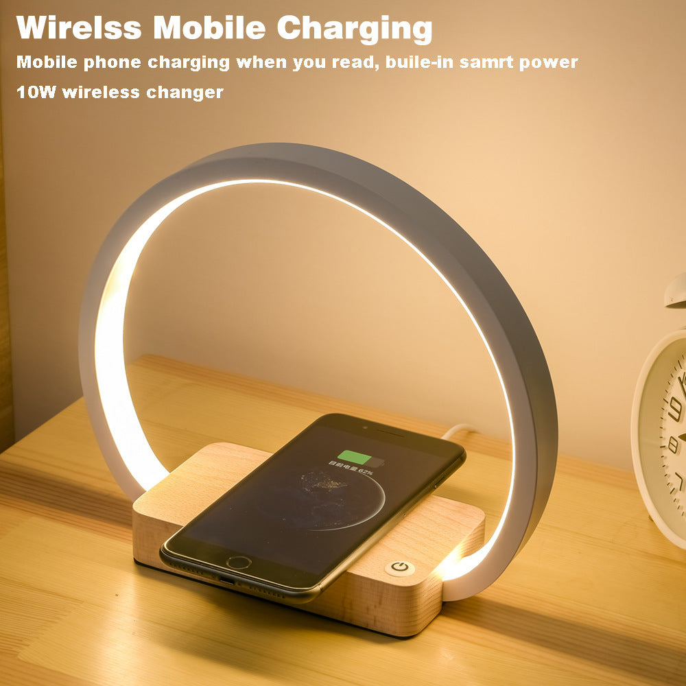 All-in-one table lamp with reading light, alarm clock, and wireless charging pad