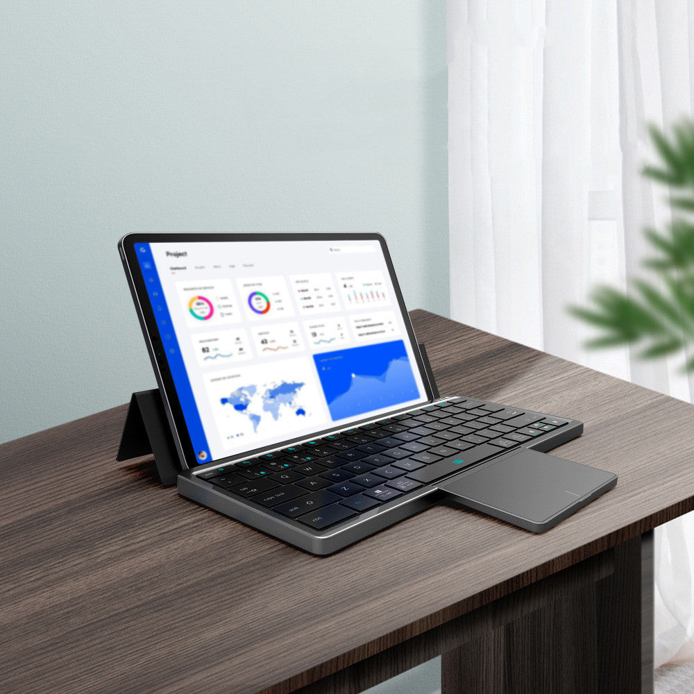 Portable wireless keyboard with touchpad and tablet setup on modern desk smart tech accessory for productivity