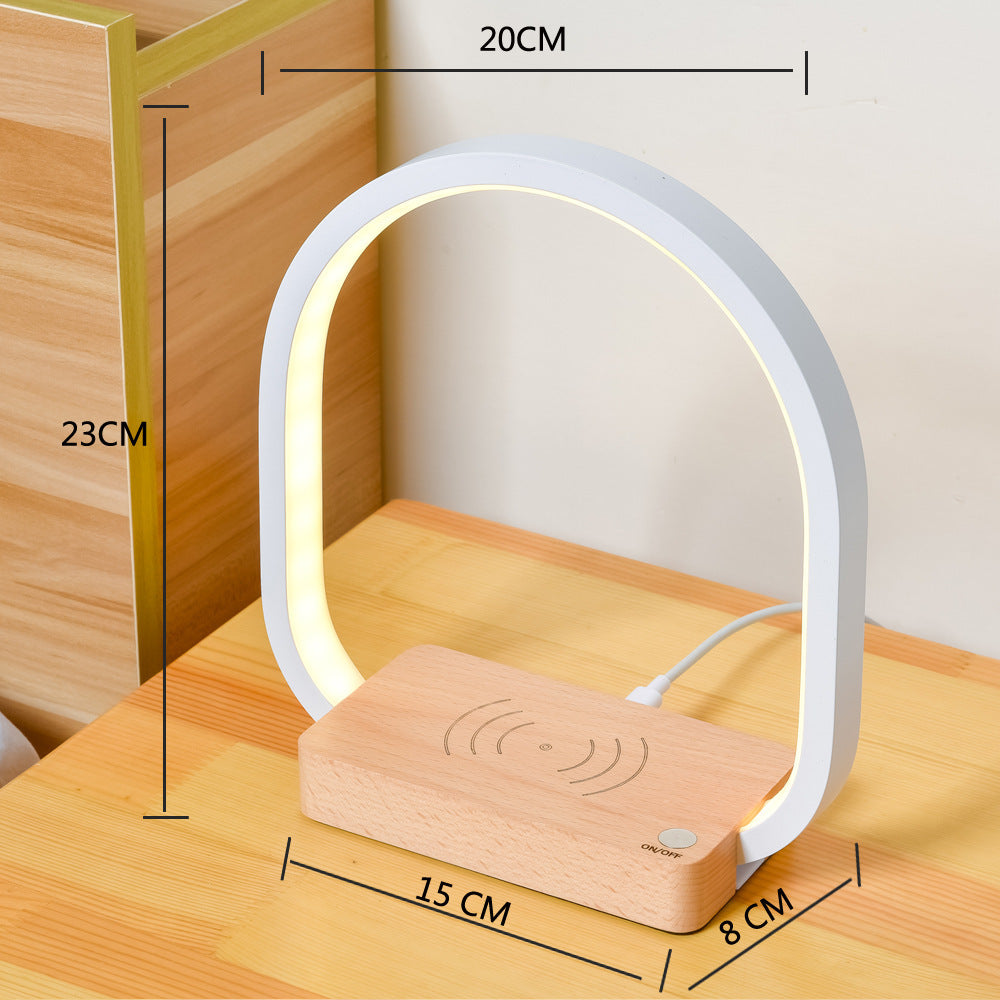 Smart table lamp with built-in clock, temperature display, and phone charging dock