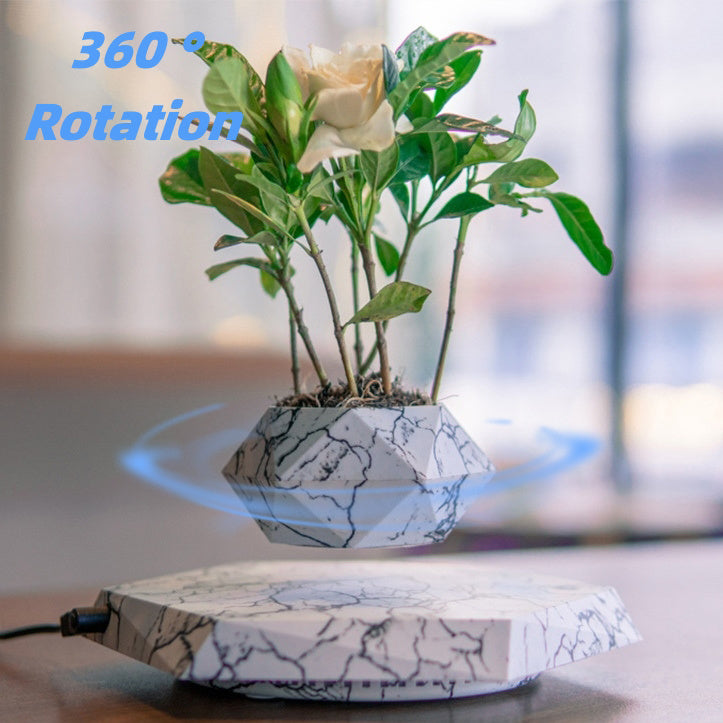 Levitating plant pot with marble-style finish and magnetic floating design for modern decor